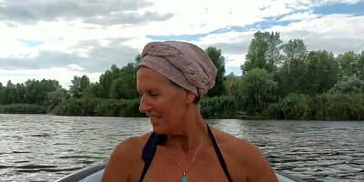 Mature lady paddles in that boat as her partner films her legs